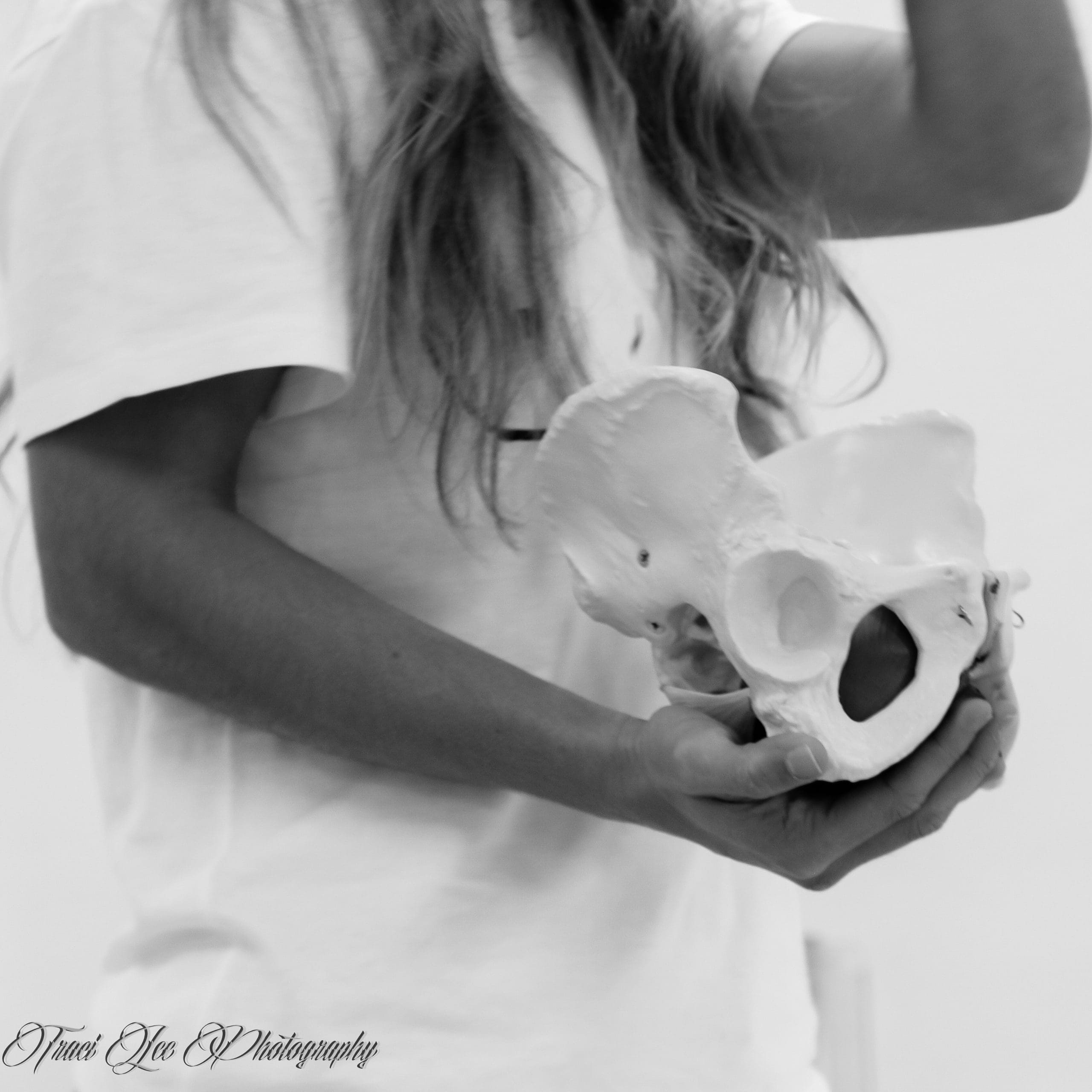 Image of a Woman Holding Pelvic Skeleton